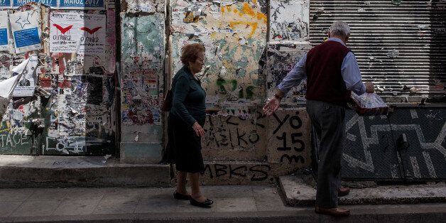 An elderly couple walks in Central Athens in front of closed shops on May 8, 2017. Greece reached an agreement with its lenders during last week. The weight of this agreement is left on Greek people to carry and especially the pensioners. (Photo by Kostis Ntantamis/NurPhoto via Getty Images)