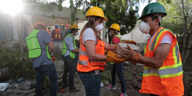 VALLE DE VAZQUEZ, MEXICO - SEPTEMBER 23: Volunteers work removing debris from a collapsed house four days after the magnitude 7.1 earthquake jolted central Mexico killing more than 250 hundred people, damaging buildings, knocking out power and causing alarm throughout the capital on September 23, 2017 in Valle de Vazquez, Mexico. Another 6.1 magnitude quake shook Southern Mexico on Saturday causing new alarm and rescuers had to suspend work. (Photo by Hector Vivas/Getty Images)