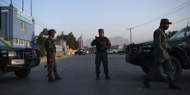 Afghan security personnel stand guard along a road near the site of suicide bomb attack on the proximity of the Alokozay Kabul International cricket ground cricket in Kabul on September 13, 2017.A suicide bomber blew himself up near a cricket stadium in the Afghan capital Kabul on Wednesday, killing three people including a policeman and wounding five others, police said. / AFP PHOTO / WAKIL KOHSAR (Photo credit should read WAKIL KOHSAR/AFP/Getty Images)