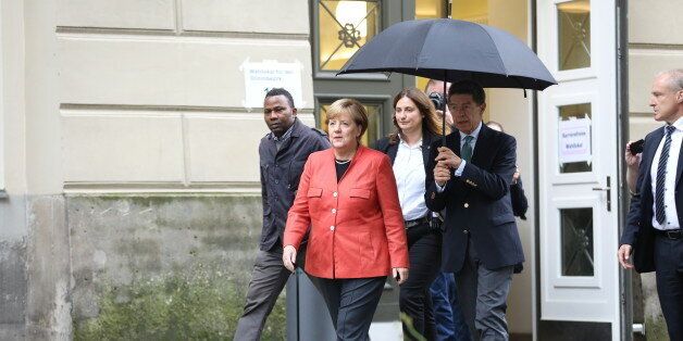 BERLIN, BERLIN-MITTE, GERMANY - 2017/09/24: Angela Merkel and Joachim Sauer on the way to a polling station with umbrella. They are voting in the 2017 Bundestag election at Wahllokal 108, student center Mensa SÃ¼d at the Humboldt University of Berlin. (Photo by Simone Kuhlmey/Pacific Press/LightRocket via Getty Images)