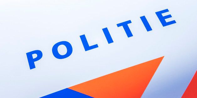 Kampen, The Netherlands - September 24, 2016: Dutch word for police - POLITIE - on the front of a Dutch police car with orange and blue stripes.