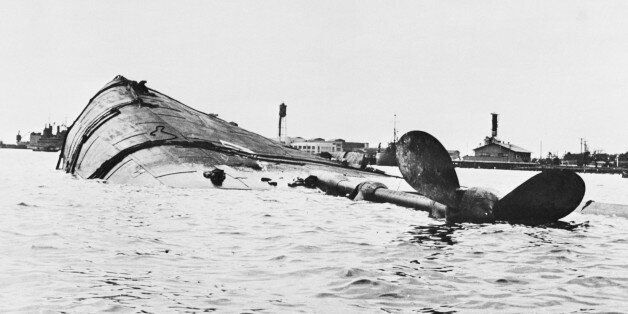 (Original Caption) Target Ship was Japs' Target. Washington, D.C.: The U.S.S. Utah is shown capsized following the Japanese attack on the Pearl Harbor, Hawaii, Naval Base on December 7. The old battleship was being used as a radio-controlled target ship by the Navy. The photo was released by the Navy department in Washington, D.C.