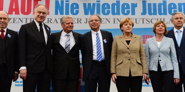 (From L) Nikolaus Schneider, Chairman of the Protestant Church in Germany, President of the World Jewish Congress, Ronald S Lauder, German President Joachim Gauck, Chairman of the Central Council of Jews in Germany, Dieter Graumann, German Chancellor Angela Merkel, German President Joachim Gauck's partner Daniela Schadt and Berlin's mayor Klaus Wowereit pose for a group photo on stage at a rally against anti-Semitism entitled 'Stand Up! Jew Hatred - Never Again!' in Berlin on September 14, 2014.
