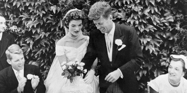(Original Caption) John F. Kennedy and Jacqueline Bouvier cutting their wedding cake after their marriage in Newport, Rhode Island. John Kennedy was then U.S. Senator from Massachusetts. Robert Kennedy at left.