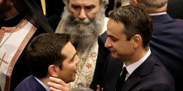 ATHENS, GREECE - MAY 31 : Prime Minister of Greece Alexis Tsipras (L) offers his condolences to son of deceased former Greek Prime Minister Constantine Mitsotakis and the President of New Democracy Party Kiriakos Mitsotakis (R) during the funeral ceremony of Former Greek Prime Minister Constantine Mitsotakis held at Metropolitan Cathedral in Athens, Greece on May 31, 2017. After the ceremony, coffin was transported to a military airport a few kilometers east of Eleusis in order to be taken to Crete Island. (Photo by Thanassis Stavrakis \ POOL/Anadolu Agency/Getty Images)