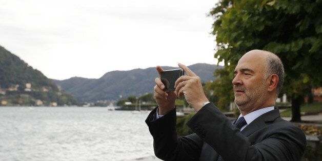 Pierre Moscovici, economic commissioner for the European Union (EU), takes a photograph with his mobile phone during the Ambrosetti Forum in Cernobbio, Italy, on Saturday, Sept. 2, 2017. Policy makers and business leaders meet at the forum to discuss local and global issues. Photographer: Stefan Wermuth/Bloomberg via Getty Images