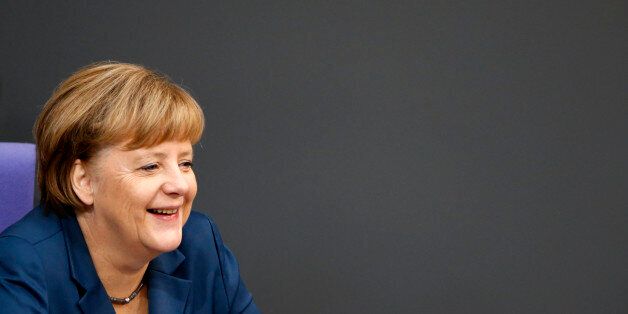 German Chancellor Angela Merkel laughs during a session of the lower house of parliament, the Bundestag in Berlin, November 28, 2013. REUTERS/Fabrizio Bensch (GERMANY - Tags: POLITICS HEADSHOT)