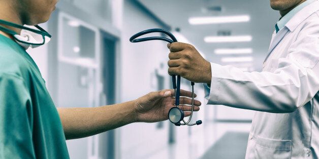 Doctor passing stethoscope to surgeon. Concept of specialist referral patients from general practitioner GP for further medication. Web banner design.