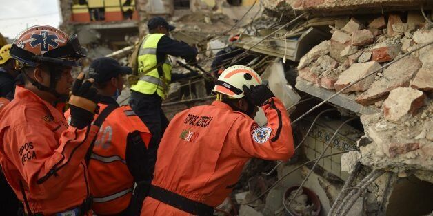 Members of the 'Topos' (Moles), a specialized rescue team, search for survivors following the 8.2 magnitude earthquake that hit Mexico's Pacific coast, in Juchitan de Zaragoza, state of Oaxaca on September 8, 2017. Mexico's most powerful earthquake in a century killed at least 35 people, officials said, after it struck the Pacific coast, wrecking homes and sending families fleeing into the streets. / AFP PHOTO / PEDRO PARDO (Photo credit should read PEDRO PARDO/AFP/Getty Images)