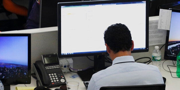 Journalists work in the Al Jazeera America newsroom in New York, August 20, 2013. Al Jazeera America, a new 24-hour news channel was launched in the United States on Tuesday. REUTERS/Brendan McDermid (UNITED STATES - Tags: MEDIA BUSINESS)