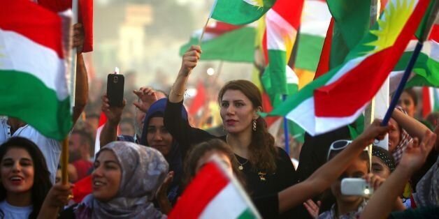 Syrian Kurds take part in a rally in the northeastern Syrian city of Qamishli on September 15, 2017, in support of an independence referendum in Arbil.Iraqi Kurdish lawmakers approved holding an independence referendum on September 25 as members of the opposition boycotted the parliament's first session in two years. / AFP PHOTO / DELIL SOULEIMAN (Photo credit should read DELIL SOULEIMAN/AFP/Getty Images)