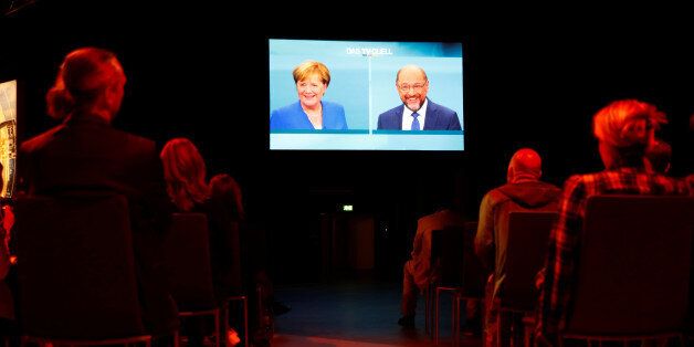 Journalists watch a TV debate between German Chancellor Angela Merkel of the Christian Democratic Union (CDU) and her challenger Germany's Social Democratic Party SPD candidate for chancellor Martin Schulz in Berlin, Germany, September 3, 2017. German voters will take to the polls in a general election on September 24. REUTERS/Fabrizio Bensch