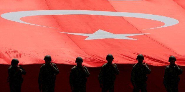 ANKARA, TURKEY - AUGUST 30 : Turkish soldiers hold a Turkish flag as they parade from the Grand National Assembly of Turkey (TBMM) to the first Turkish Grand National Assembly building in the Ulus district during the celebrations to mark 95th Anniversary of Turkeys Victory Day which commemorates decisive battle in country's 1919-1922 Independence War in Ankara, Turkey on August 30, 2017. (Photo by Murat Kaynak/Anadolu Agency/Getty Images)