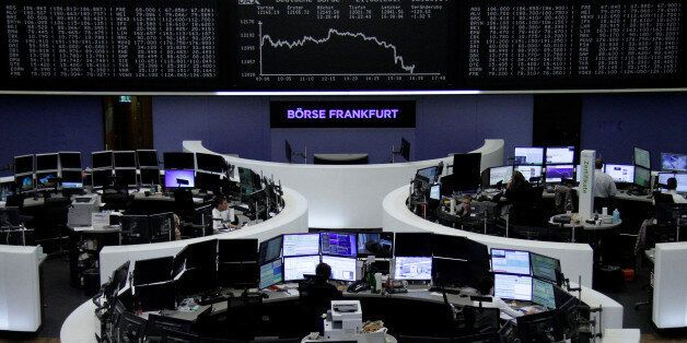 Traders work in front of the German share price index, DAX board, at the stock exchange in Frankfurt, Germany, August 21, 2017. REUTERS/Staff/Remote