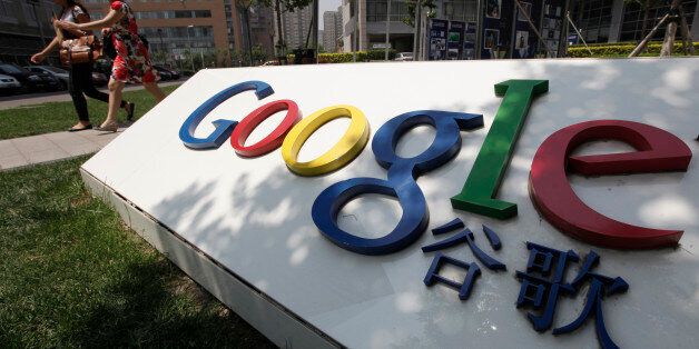 Women walk past the logo of Google in front of its former headquarters, in Beijing June 2, 2011. Suspected Chinese hackers tried to steal the passwords of hundreds of Google email account holders, including those of senior U.S. government officials, Chinese activists and journalists, the Internet company said. This logo has been updated and is no longer in use. REUTERS/Jason Lee (CHINA - Tags: SCI TECH POLITICS)