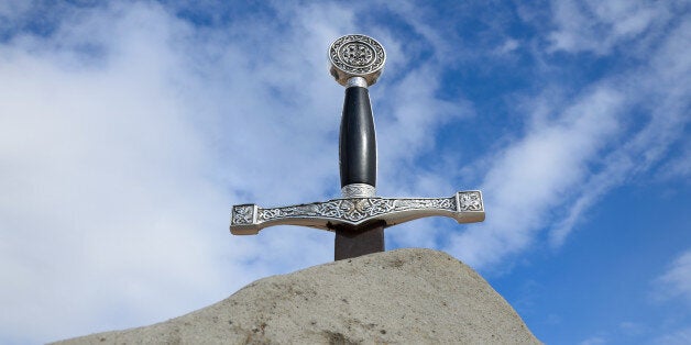 Arthur's sword is thrust into the rock. It is photographed from bottom against the sky.