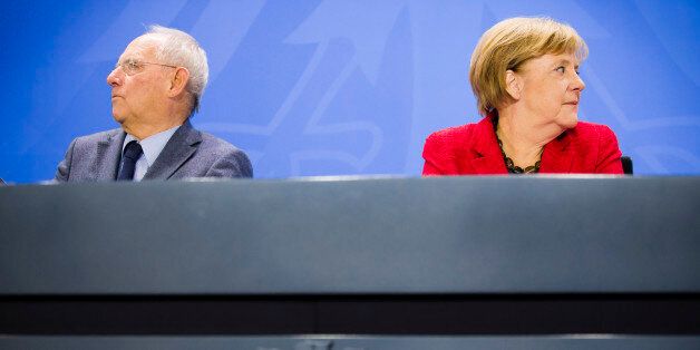 BERLIN, GERMANY - OCTOBER 14: German Finance Minister Wolfgang Schaeuble (L) and German Chancellor Angela Merkel speaks to the media on October 14, 2016 in Berlin, Germany. (Photo by Thomas Trutschel/Photothek via Getty Images)