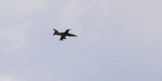 A Syrian pro-government forces plane flies above Bir Qabaqib, more than 40 kilometres west of Deir Ezzor, after the infantry took control of the area on their way to Kobajjep in the ongoing battle against Islamic State (IS) group jihadists on September 4, 2017. Syria's army are fighting the Islamic State group on the edges of Deir Ezzor seeking to break the siege of a government enclave and oust the jihadists from a key stronghold. / AFP PHOTO / George OURFALIAN (Photo credit should read GEORGE OURFALIAN/AFP/Getty Images)