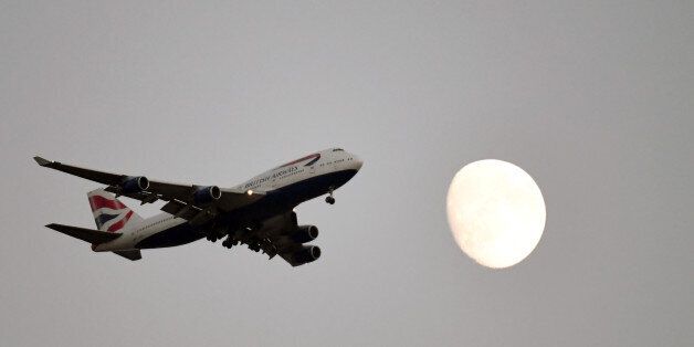 LAS VEGAS, NV - SEPTEMBER 02: A British Ariways jet flies in front of the moon en route to McCarran International Airport on September 2, 2017 in Las Vegas, Nevada. (Photo by Ethan Miller/Getty Images)
