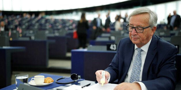 European Commission President Jean-Claude Juncker checks notes before addressing the European Parliament...