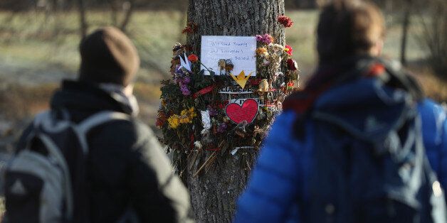 FREIBURG IM BREISGAU, GERMANY - DECEMBER 08: Passers-by stop to look at flowers and messages left by mourners that adorn a tree near the spot where Maria L., a 19-year-old medical student, was raped and murdered on December 8, 2016 in Freiburg im Breisgau, Germany. Police have arrested Hussein K., a refugee from Afghanistan who was 16 at the time of the October murder, after identifying him through CCTV camera images and DNA evidence. The likely fact that a refugee is responsible for the murder has grown into a political issue, with a local branch of the right-wing AfD (Alternative fuer Deutschland) political party quick to point a finger at what they deem as Germany's over-liberal policy on admitting over one million refugees and migrants since 2015. Meanwhile critics have blasted German television station ARD for failing to report on the arrest in its Tagesschau news broadcast in what many right-leaning analysts see as pro-refugee bias by the media. (Photo by Sean Gallup/Getty Images)
