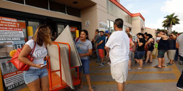 MIAMI, FLORIDA--SEPT. 8, 2017--Hundreds wait in like at Home Depot in Miami to get supplies like sheets of plywood, and anything else they can find, to board up their homes. Police were on the scene to keep things orderly on Friday, Sept. 8, 2017. Hurricane Irma is bearing down on Miami and due to hit Saturday night. (Photo by Carolyn Cole/Los Angeles Times via Getty Images)