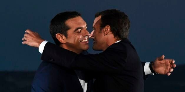 French president Emmanuel Macron (R) embraces Greek Prime Minister Alexis Tsipras as he arrives to deliver a speech on the Pnyx hill with the Acropolis in the backround in Athens on September 7, 2017, as part of his two-day official visit to Greece.Macron was holding talks on September 7 with Greek Prime Minister Alexis Tsipras and President Prokopis Pavlopoulos. / AFP PHOTO / ARIS MESSINIS (Photo credit should read ARIS MESSINIS/AFP/Getty Images)