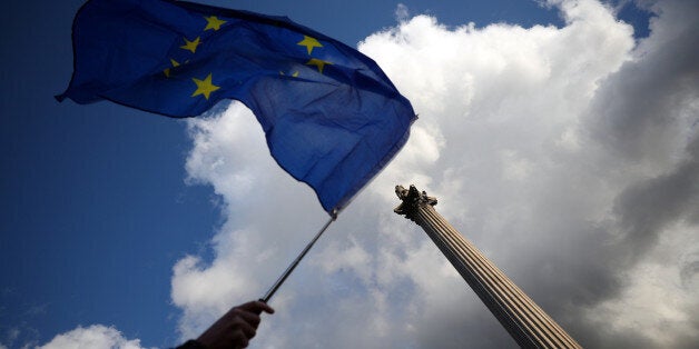 A demonstrator waves a European Union flag in front of Nelson's column in London, Britain, September 13, 2017. REUTERS/Hannah McKay