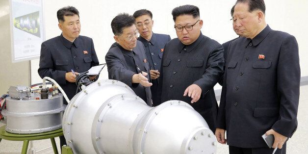 TOPSHOT - This undated picture released by North Korea's official Korean Central News Agency (KCNA) on September 3, 2017 shows North Korean leader Kim Jong-Un (C) looking at a metal casing with two bulges at an undisclosed location.North Korea has developed a hydrogen bomb which can be loaded into the country's new intercontinental ballistic missile, the official Korean Central News Agency claimed on September 3. Questions remain over whether nuclear-armed Pyongyang has successfully miniaturised its weapons, and whether it has a working H-bomb, but KCNA said that leader Kim Jong-Un had inspected such a device at the Nuclear Weapons Institute. / AFP PHOTO / KCNA VIA KNS / STR / South Korea OUT / REPUBLIC OF KOREA OUT ---EDITORS NOTE--- RESTRICTED TO EDITORIAL USE - MANDATORY CREDIT 'AFP PHOTO/KCNA VIA KNS' - NO MARKETING NO ADVERTISING CAMPAIGNS - DISTRIBUTED AS A SERVICE TO CLIENTSTHIS PICTURE WAS MADE AVAILABLE BY A THIRD PARTY. AFP CAN NOT INDEPENDENTLY VERIFY THE AUTHENTICITY, LOCATION, DATE AND CONTENT OF THIS IMAGE. THIS PHOTO IS DISTRIBUTED EXACTLY AS RECEIVED BY AFP. / (Photo credit should read STR/AFP/Getty Images)