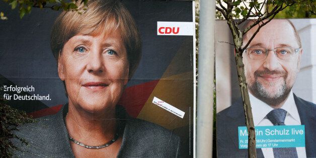 Election campaign posters of the Christian Democratic Union party (CDU) with a headshot of German Chancellor Angela Merkel (L) and of Germany's Social Democratic Party SPD candidate for chancellor Martin Schulz for the upcoming general elections are pictured in Berlin, Germany, September 11, 2017. REUTERS/Fabrizio Bensch