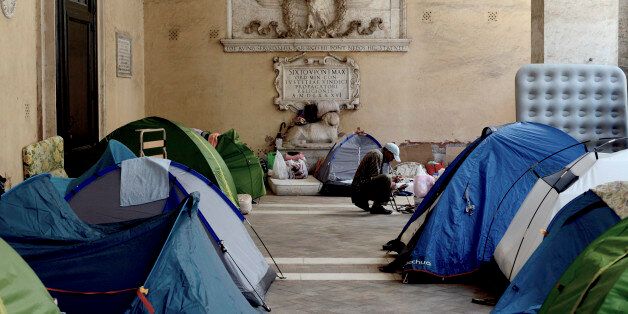 ROME, ITALY - SEPTEMBER 08:Dozens of families including children continue to live in the colonnade of Basilica of the 12 Apostles in Piazza SS Apostoli, on September 8, 2017 in Rome, Italy. The families were evicted on August 10, 2017 from a building in Quintavalle Street in the Cinecitta district , after occupying it for 3 years. They have moved to the Colonnade of the Basilica of the 12 Apostles in Piazza SS Apostoli after receiving permission from the friars to wait there until their meeting in the prefecture, which will determine where they will be re-housed.(Photo by Simona Granati - Corbis/Corbis via Getty Images)
