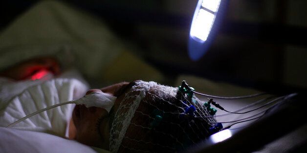 A coma patient has his brain parameters stimulated with flash lights to understand when he is ready to be stimulated, at Sant'Anna hospital in Crotone, south of Italy, December 16, 2014. Under pressure to curb the euro zone's second-largest public debt, successive Italian governments have slashed funding for regions by 10 billion euros in the last five years. Regional authorities in turn have targeted the largest item on their own budget: health spending. In Calabria, where Sant'Anna is located, the health service deficit has fallen to 40 million euros from 250 million euros since 2009. Because cuts are politically difficult, they have hit all of Calabria's hospitals in the same way, regardless of medical or economic performance. That means the Sant'Anna ? whose success rate in reawakening people from comas is nearly 20 percent higher than the Italian average ? faces similar cuts to those in any other hospital in the region. To match Insight ITALY-HEALTH/AWAKENINGS Picture taken December 16, 2014. REUTERS/Max Rossi (ITALY - Tags: HEALTH POLITICS SOCIETY BUSINESS)