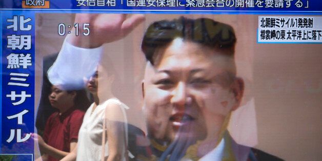 TOKYO, JAPAN - AUGUST 29: Pedestrians are reflected in a monitor showing an image of North Korean leader Kim Jong-Un in a news program reporting on North Korea's missile launch on August 29, 2017 in Tokyo, Japan. The ballistic missile launched by North Korea flew over Northern Japan and fell into the Pacific Ocean. (Photo by Tomohiro Ohsumi/Getty Images)