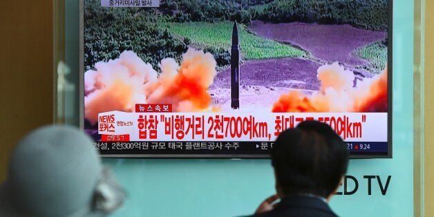 TOPSHOT - People watch a television news screen showing file footage of a North Korean missile launch, at a railway station in Seoul on August 29, 2017.Nuclear-armed North Korea fired a ballistic missile over Japan and into the Pacific Ocean on August 29 in a major escalation by Pyongyang amid tensions over its weapons ambitions. / AFP PHOTO / JUNG Yeon-Je (Photo credit should read JUNG YEON-JE/AFP/Getty Images)
