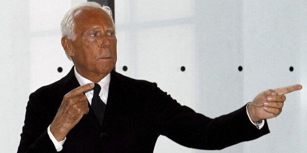 Special fashion ambassador for Milan's Expo 2015 Italian designer Giorgio Armani gestures during a photo call before his fashion show to celebrate the 40th anniversary of his career and to mark the opening of the Expo 2015 in Milan, April 30, 2015. The Milan Expo will open in the city on May 1, following the 2010 Shanghai Expo. Officials are counting on some 20 million visitors to the six month-long exhibition of products and technologies from around the world. REUTERS/Alessandro Garofalo
