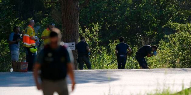 Spanish policemen check the site where Moroccan suspect Younes Abouyaaqoub was shot on August 21, 2017 near Sant Sadurni d'Anoia, south of Barcelona, four days after the Barcelona and Cambrils attacks that killed 15 people.Spanish police said on August 21, 2017 that they have identified the driver of the van that mowed down pedestrians on the busy Las Ramblas boulevard in Barcelona, killing 13.The 22-year-old Moroccan Younes Abouyaaqoub is believed to be the last remaining member of a 12-man cell still at large in Spain or abroad, with the others killed by police or detained over last week's twin attacks in Barcelona and the seaside resort of Cambrils that claimed 14 lives, including a seven-year-old boy. / AFP PHOTO / LLUIS GENE (Photo credit should read LLUIS GENE/AFP/Getty Images)