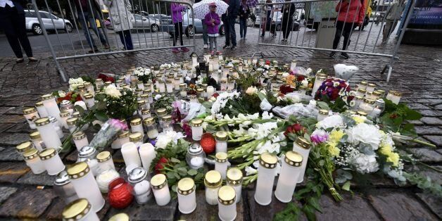 People light memorial candles at the Turku Market Square for the victims of a stabbing spree on August 19, 2017 in Turku.Police are now investigating a stabbing spree in Finland that left two people dead as a terrorist attack, police said Saturday, identifying the suspect as an 18-year-old Moroccan citizen. / AFP PHOTO / Lehtikuva / Vesa Moilanen / Finland OUT (Photo credit should read VESA MOILANEN/AFP/Getty Images)