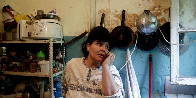 Emine Kilic, a Turkish squatter and mother of 10, speaks on the phone inside a kitchen at the