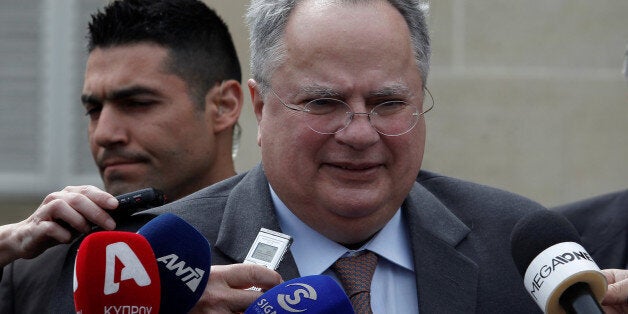 Greek Foreign Minister Nikos Kotzias talks to media after a meeting with Cypriot President Nicos Anastasiades at the presidential palace in Nicosia, Cyprus March 27, 2017. REUTERS/Yiannis Kourtoglou