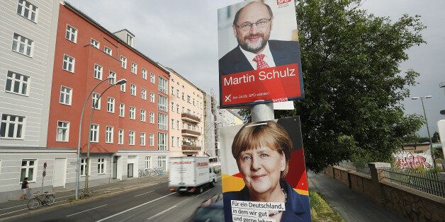 BERLIN, GERMANY - AUGUST 24: Cars drive past election campaign posters that depict German Social Democrat (SPD) and chancellor candidate Martin Schulz and German Chancellor and Christian Democrat (CDU) Angela Merkel on August 24, 2017 in Berlin, Germany. Germany will hold federal elections on September 24. Merkel is seeking a fourth term and currently holds an approximate 14-point lead over Schulz, her main rival. Both the German Greens Party and the Free Democrats (FDP) are hoping to position themselves to be part of the next coalition government. The far-right Alternative for Germany (AfD) will likely finish above the 5% election votes minimum and hence win seats in the Bundestag. (Photo by Sean Gallup/Getty Images)