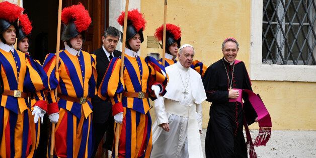 Pope Francis, flanked by Archbishop Georg Gaenswein, walks past Swiss Guards on is way to a private audience with Britain's Prince Charles and his wife Camilla, Duchess of Cornwall, at the Vatican, April 4, 2017. REUTERS/ Vincenzo Pinto/Pool