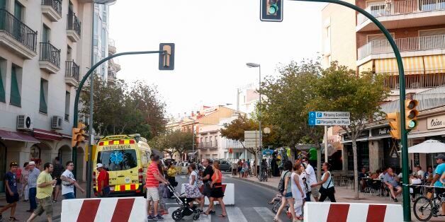 People walk past concrete barriers displayed to avoid vehicles to go through before a protest against terrorism in Cambrils following Barcelona and Cambrils attacks on August 25, 2017, one week after a van ploughed into the crowd, killing 13 persons and injuring over 100.Drivers have ploughed on August 17, 2017 into pedestrians in two quick-succession, separate attacks in Barcelona and another popular Spanish seaside city, leaving 14 people dead and injuring more than 100 others. In the first incident, which was claimed by the Islamic State group, a white van sped into a street packed full of tourists in central Barcelona on Thursday afternoon, knocking people out of the way and killing 13 in a scene of chaos and horror. Some eight hours later in Cambrils, a city 120 kilometres south of Barcelona, an Audi A3 car rammed into pedestrians, injuring six civilians -- one of them critical -- and a police officer, authorities said. / AFP PHOTO / PAU BARRENA (Photo credit should read PAU BARRENA/AFP/Getty Images)