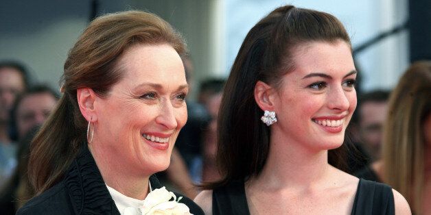 Actresses Meryl Streep (L) and Anne Hathaway pose for photographers as they arrive for the screening of their film