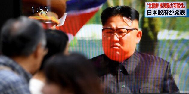 Pedestrians walk past a television screen broadcasting a television news programme on a possible North Korean nuclear test in Tokyo on September 3, 2017. North Korea appeared to carry out a sixth nuclear test on September 3, with seismic monitors measuring an 'explosion' of 6.3 magnitude near its main test site, sending tensions over its weapons ambitions to new heights. / AFP PHOTO / Toshifumi KITAMURA (Photo credit should read TOSHIFUMI KITAMURA/AFP/Getty Images)