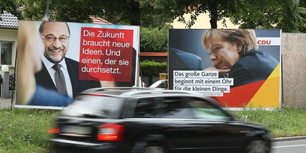 BERLIN, GERMANY - AUGUST 24: A car drives past election campaign billboards that depict German Social Democrat (SPD) and chancellor candidate Martin Schulz and German Chancellor and Christian Democrat (CDU) Angela Merkel on August 24, 2017 in Berlin, Germany. Germany will hold federal elections on September 24. Merkel is seeking a fourth term and currently holds an approximate 14-point lead over Schulz, her main rival. Both the German Greens Party and the Free Democrats (FDP) are hoping to position themselves to be part of the next coalition government. The far-right Alternative for Germany (AfD) will likely finish above the 5% election votes minimum and hence win seats in the Bundestag. (Photo by Sean Gallup/Getty Images)