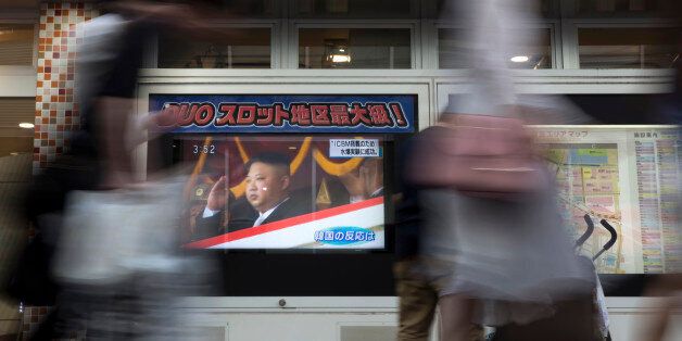 TOKYO, JAPAN - SEPTEMBER 03: Pedestrians walk past a monitor showing an image of North Korean leader Kim Jong-Un in a news program reporting on North Korea's 6th nuclear test on September 3, 2017 in Tokyo, Japan. South Korea, Japan and the U.S. detected an artificial earthquake from Kilju, northern Hamgyong Province of North Korea. State news agency KCNA announced Pyongyang have successfully carried out a test of a hydrogen bomb, which could be loaded to the Intercontinental Ballistic Missile (ICBM) missile. (Photo by Tomohiro Ohsumi/Getty Images)