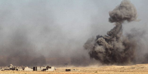 Smoke rises in the background as Iraqi forces backed by the Hashed Al-Shaabi (Popular Mobilization units) advance towards the town of Tal Afar, west of Mosul, after the Iraqi government announced the beginning of the operation to retake it from the control of the Islamic State (IS) group on August 22, 2017. Iraqi forces recaptured from the Islamic State group the first two districts of jihadist bastion Tal Afar, as the Pentagon chief visited Baghdad in a show of support. / AFP PHOTO / AHMAD AL-RUBAYE (Photo credit should read AHMAD AL-RUBAYE/AFP/Getty Images)