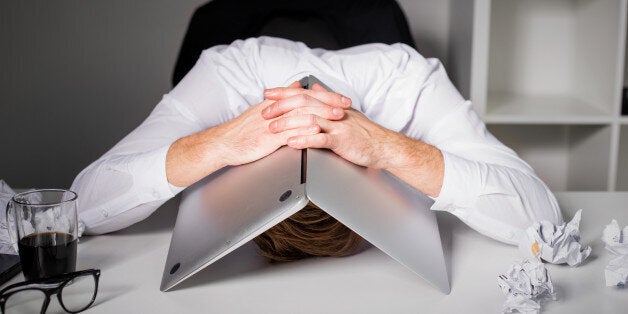 Man hiding under laptop