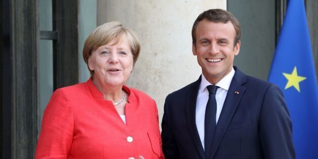French president Emmanuel Macron (R) poses with German Chancellor Angela Merkel upon her arrival at the Elysee Palace in Paris on August 28, 2017.Seven African and European leaders are meeting in Paris today to discuss ways to stem the flow of migrants into Europe from northern Africa. German Chancellor Angela Merkel, Spanish and Italian prime ministers Mariano Rajoy and Paulo Gentiloni, and Europe's top diplomat Federica Mogherini will join the talks. / AFP PHOTO / LUDOVIC MARIN (Photo credit should read LUDOVIC MARIN/AFP/Getty Images)