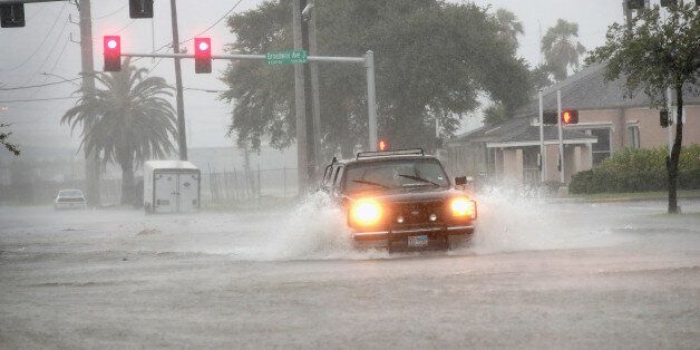 GALVESTON, TX - AUGUST 26: A vehicle navigates a street flooded by rain from Hurricane Harvey on August 26, 2017 in Galveston, Texas. Harvey, which made landfall north of Corpus Christi late last night, is expected to dump upwards to 40 inches of rain in Texas over the next couple of days. (Photo by Scott Olson/Getty Images)